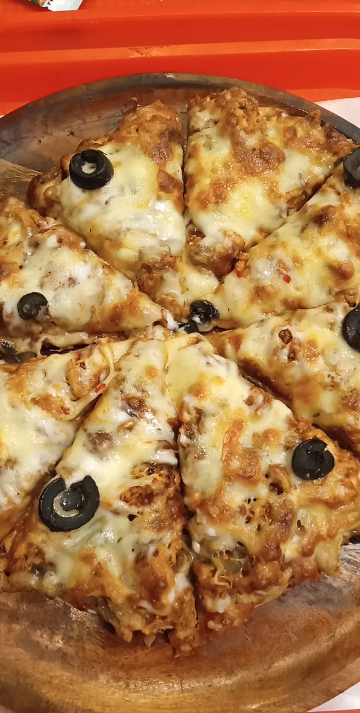 Homemade BBQ chicken pizza with red onion and cheese; illustrative toppings photograph