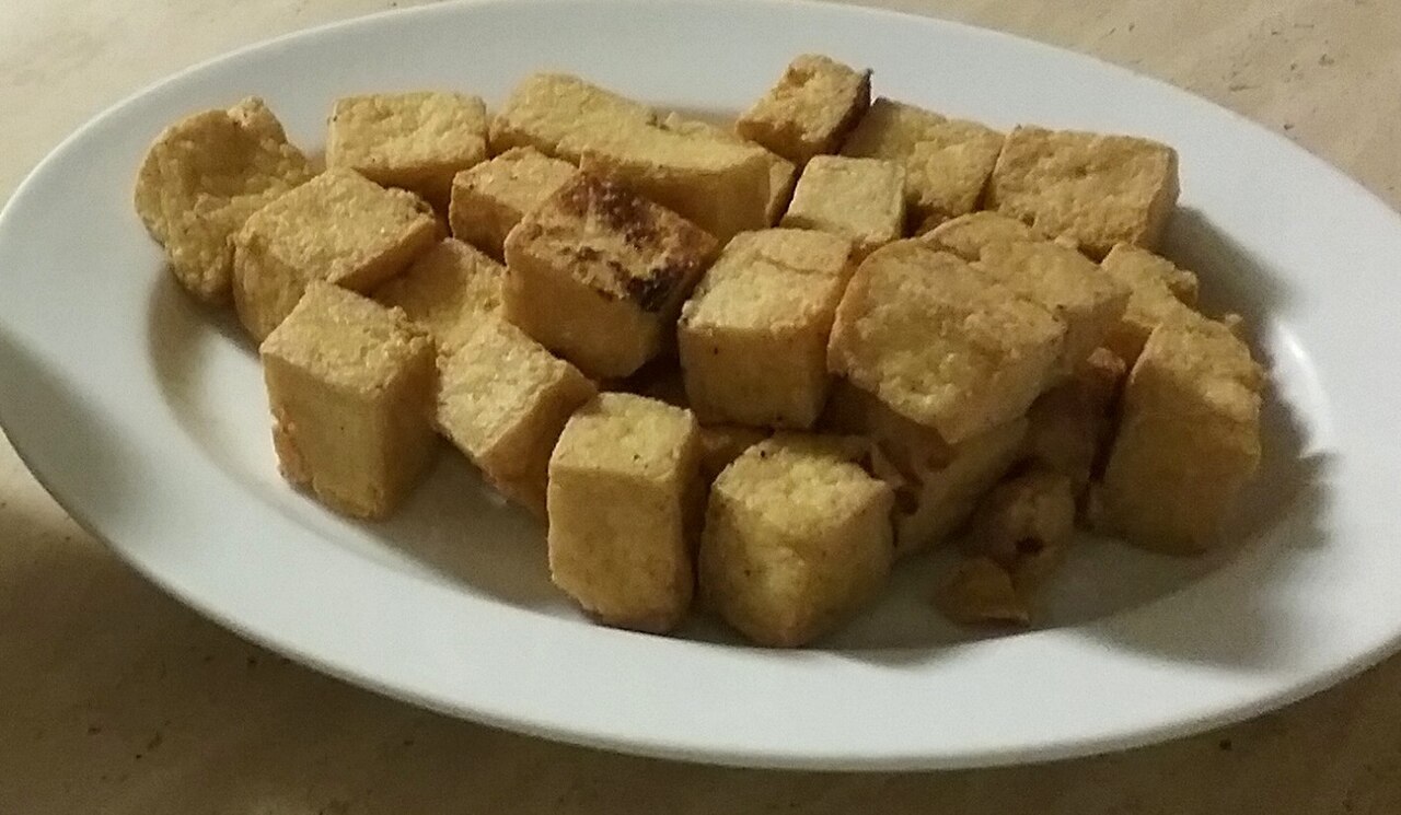 Illustrative fried tofu cubes and dipping sauce; different cooking technique from this oven recipe