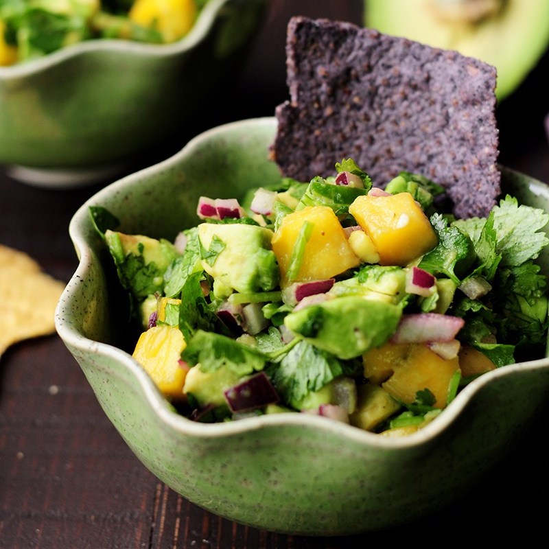 Colorful bowl of diced mango and avocado salsa, illustrative of the quick party salsa