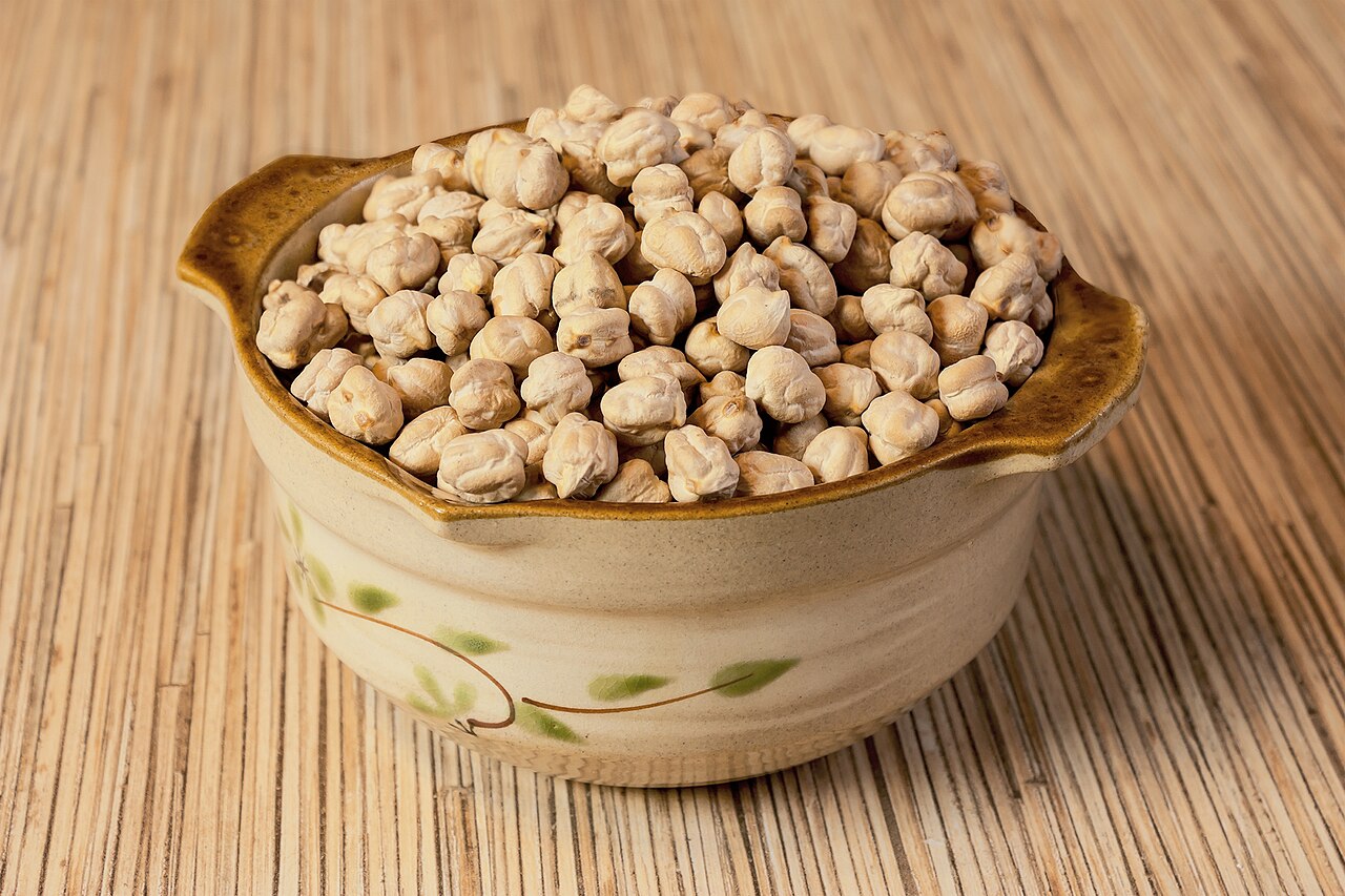 Plain chickpeas in a ceramic bowl before seasonings; an illustration of the base ingredient