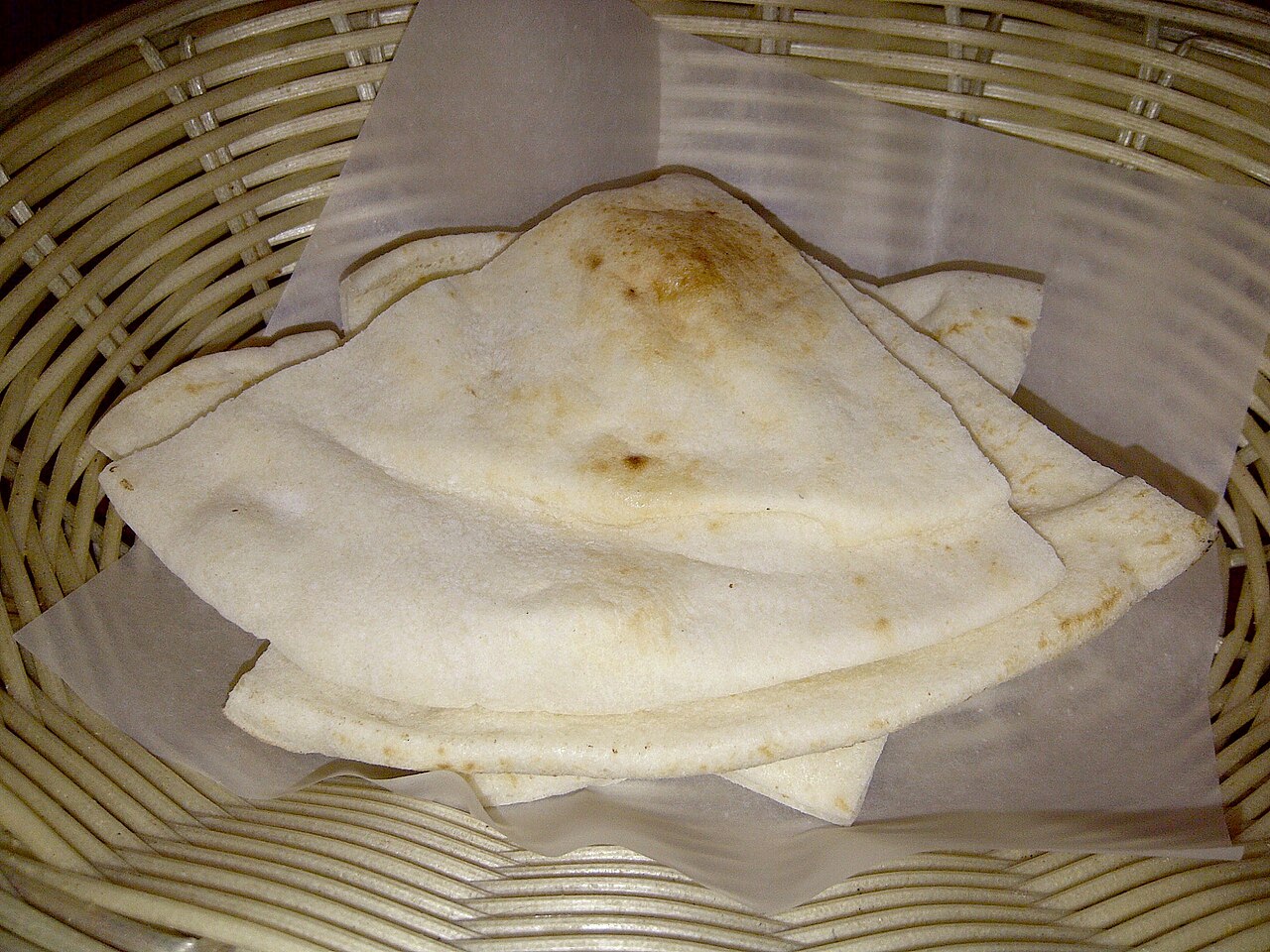 Whole pita bread before cutting into triangles and baking, illustrating the base ingredient rather than finished chips