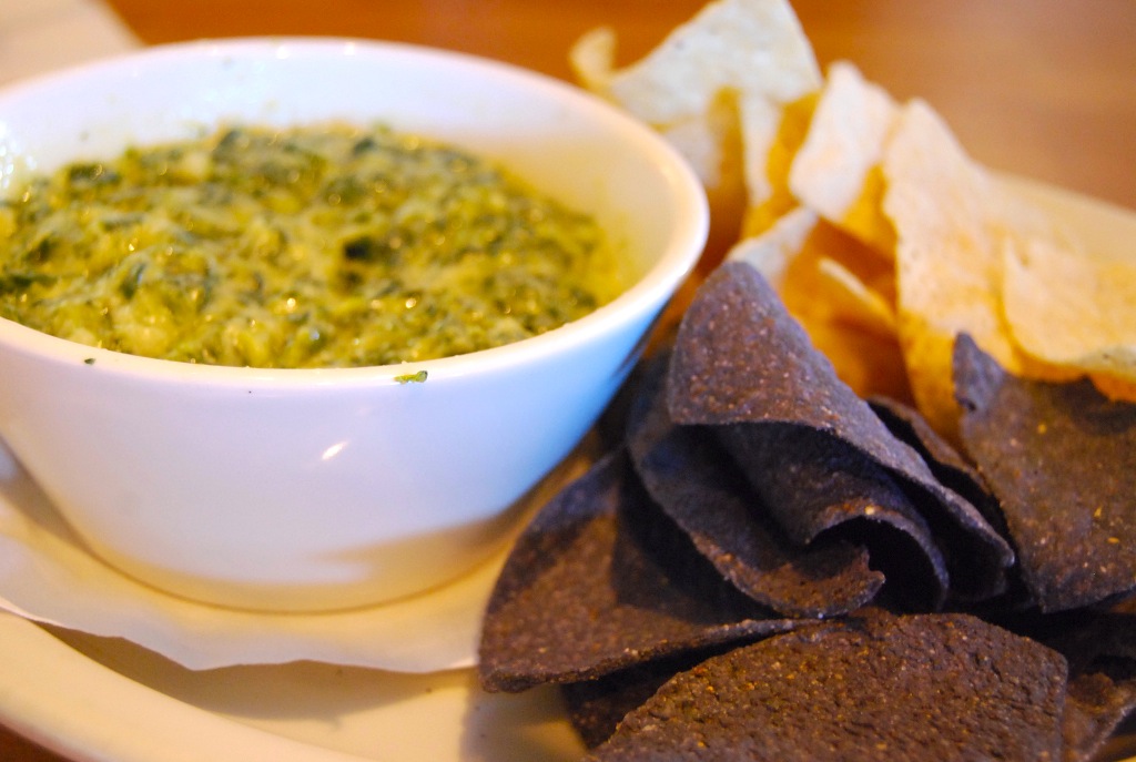 Creamy spinach-artichoke dip served in a bowl, illustrating the cups' filling